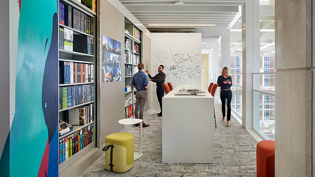 A few people in a library.