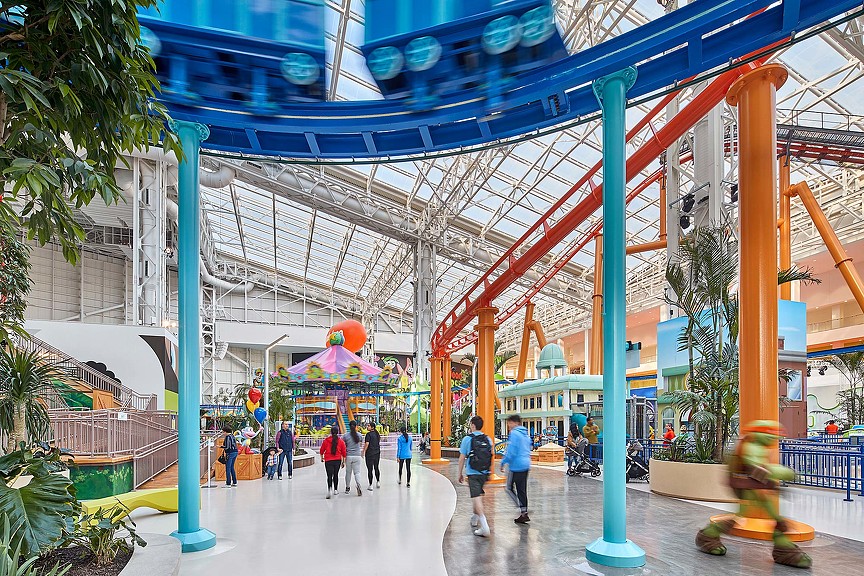 A group of people walking under a covered walkway.