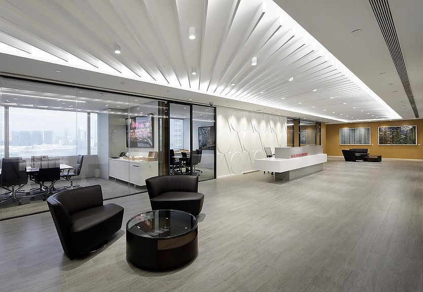 A large room with a large glass wall and a large table with chairs.