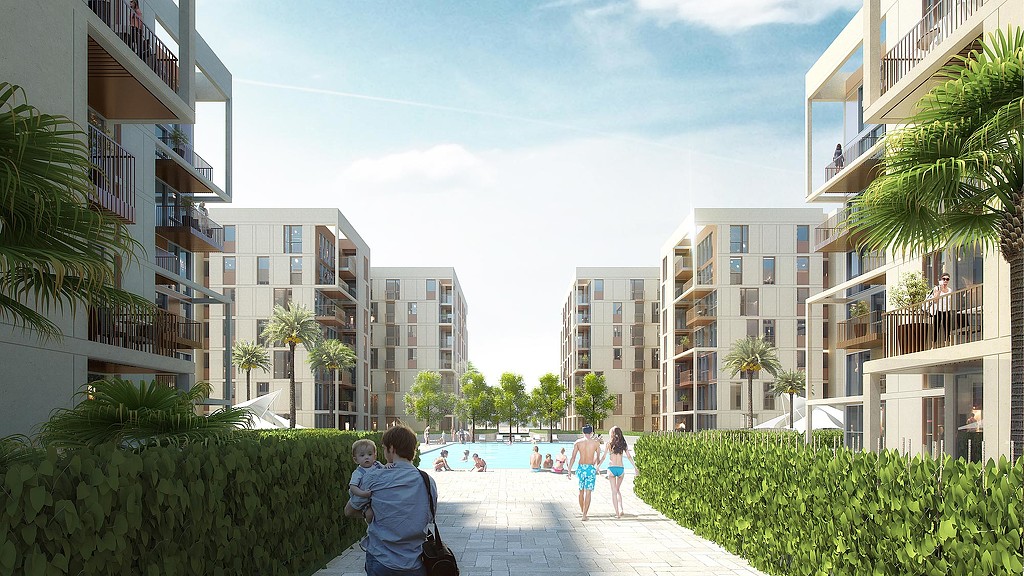 People walking on a walkway between buildings.