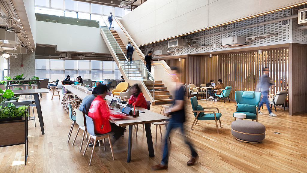 People sitting at tables in a building.