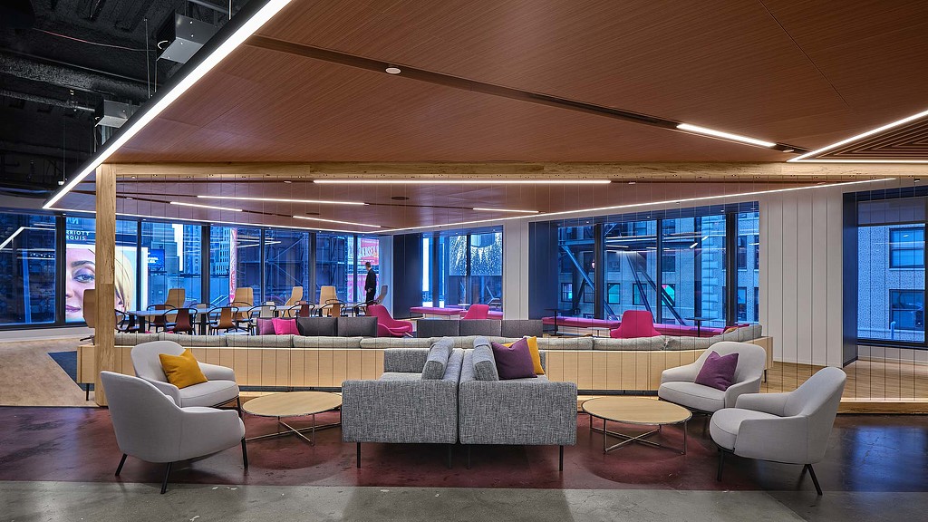 A room with a large glass wall and a large room with a large window and a couch and.