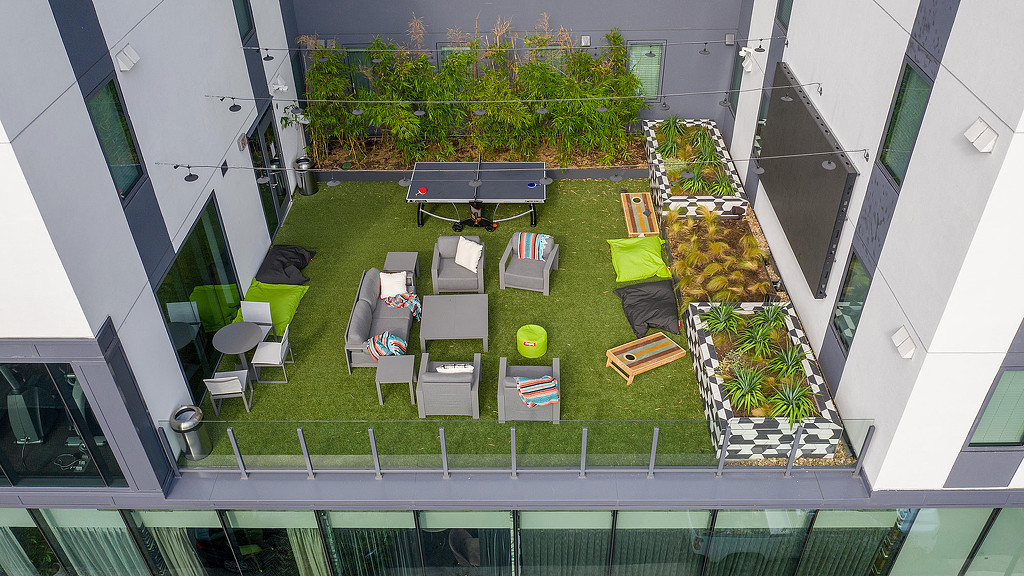 A building with a lawn and chairs.