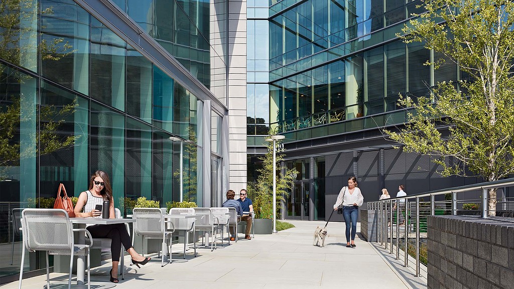 A person sitting at a table outside.
