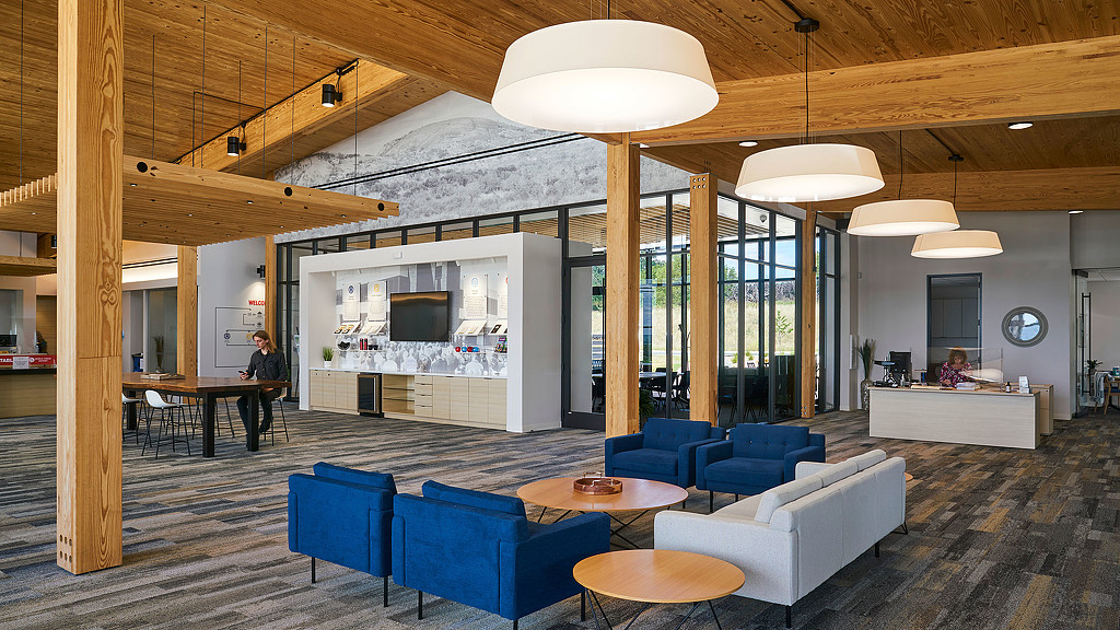 A room with blue couches and a table.