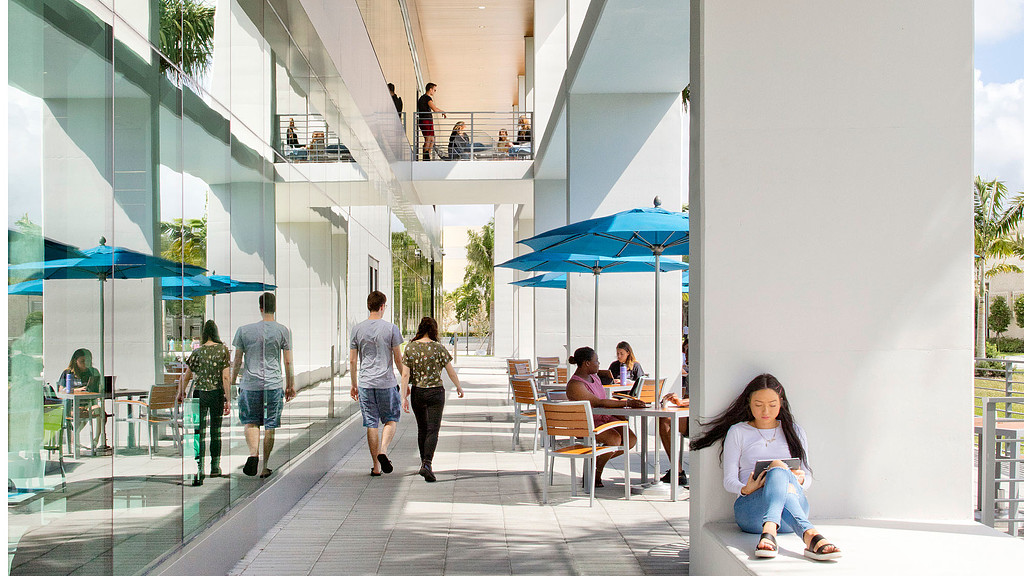 A group of people walking around a building.
