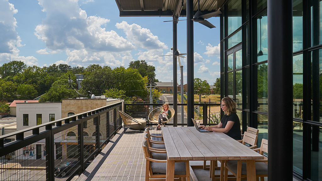 A person sitting at a table outside.