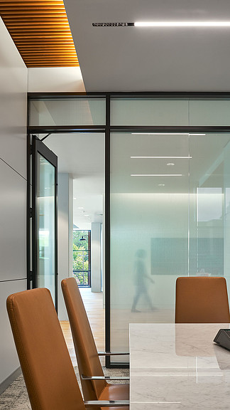 A room with a glass door and chairs.