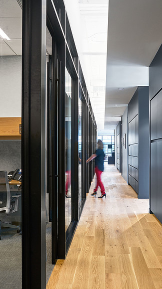 A person walking down a hall.