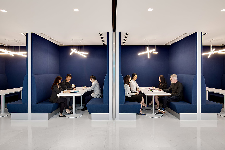 A group of people sitting around a table.