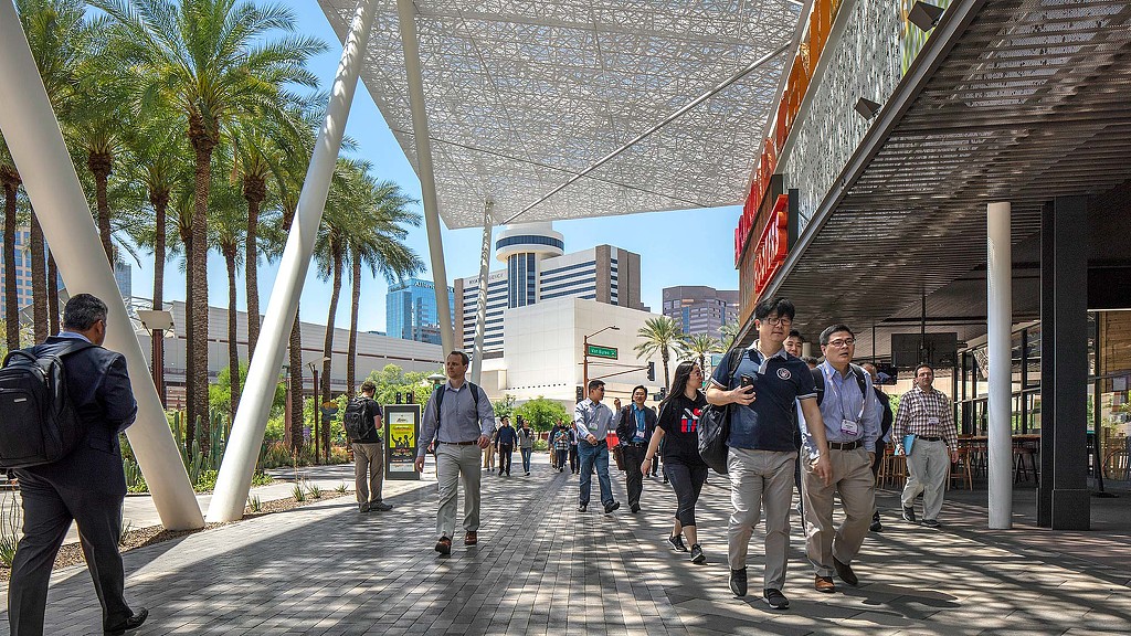A group of people walking on a street.