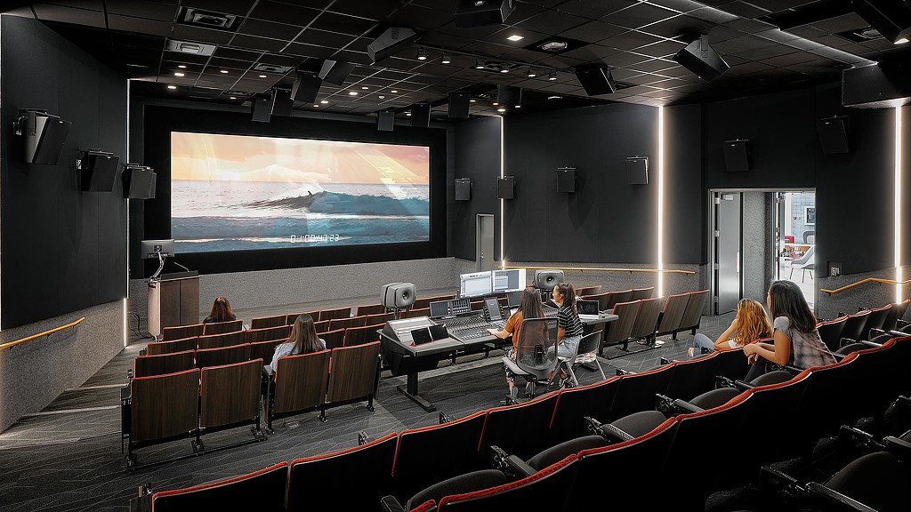 A group of people sitting in a conference room.
