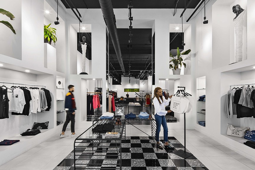 A woman and a man in a clothing store.