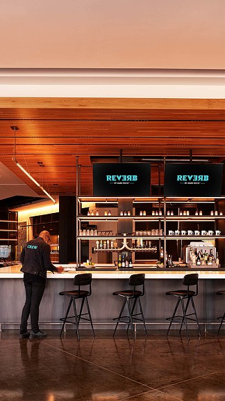 A person standing in front of a bar.