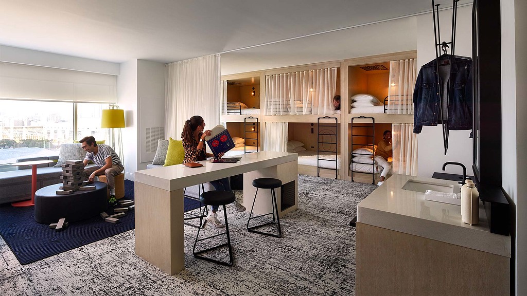 A room with a desk and a bed.