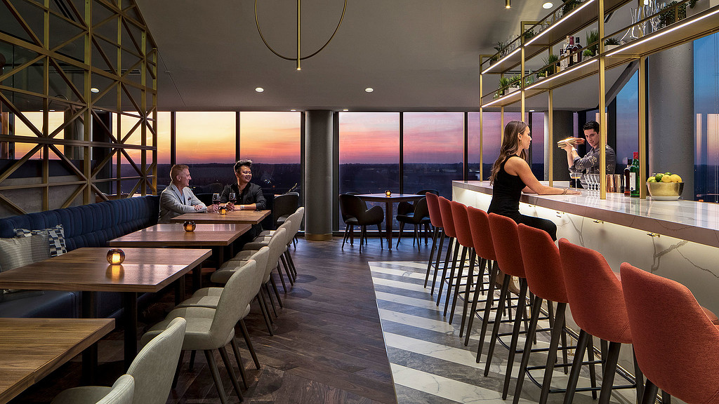 A group of people sitting at a table in a restaurant.
