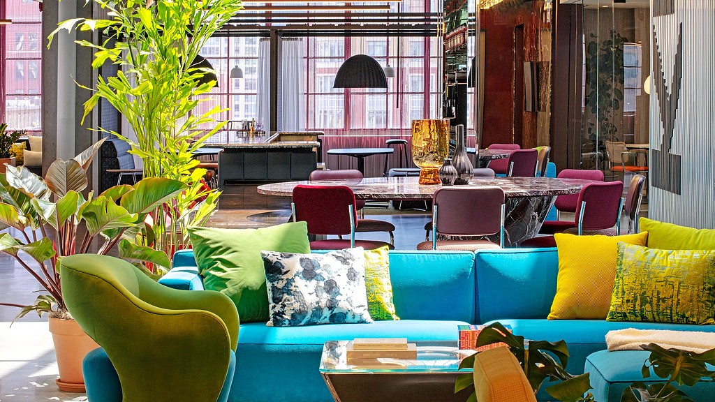 A room with colorful couches and chairs.