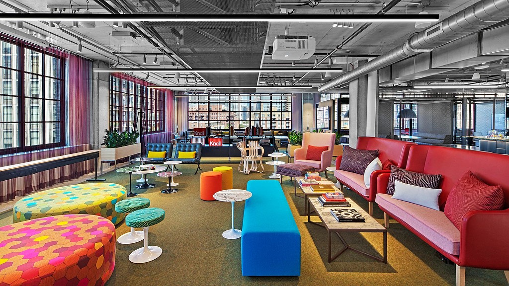 A room with colorful couches and tables.