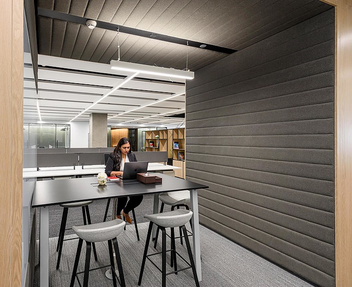 A person sitting at a table with a laptop.