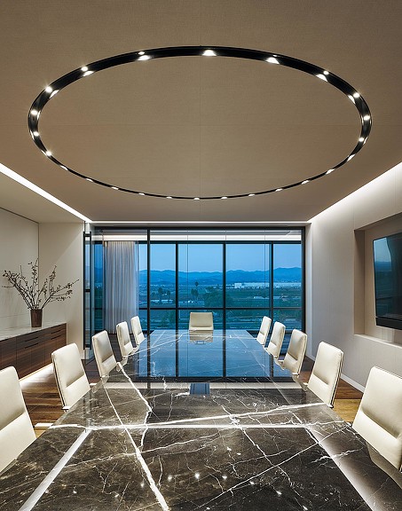 A room with a large chandelier and a pool.