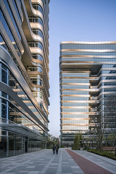 A few people walking outside of a building.
