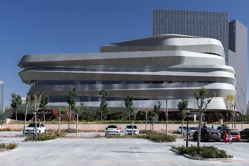 A building with cars parked in front.