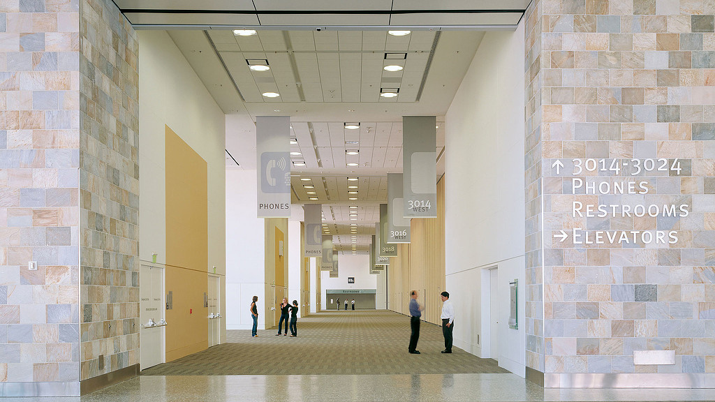 A group of people walking through a building.