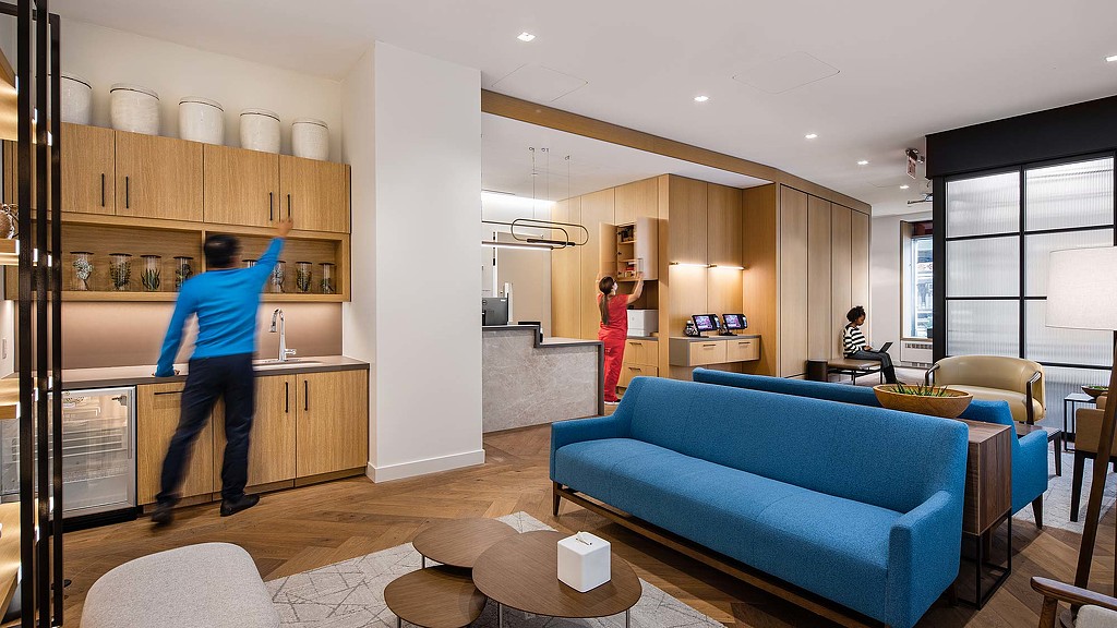 A man and a woman in a living room.