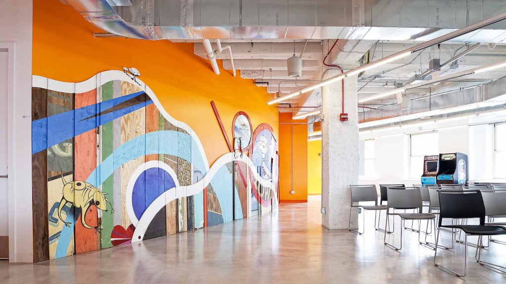 A room with a large mural on the wall.