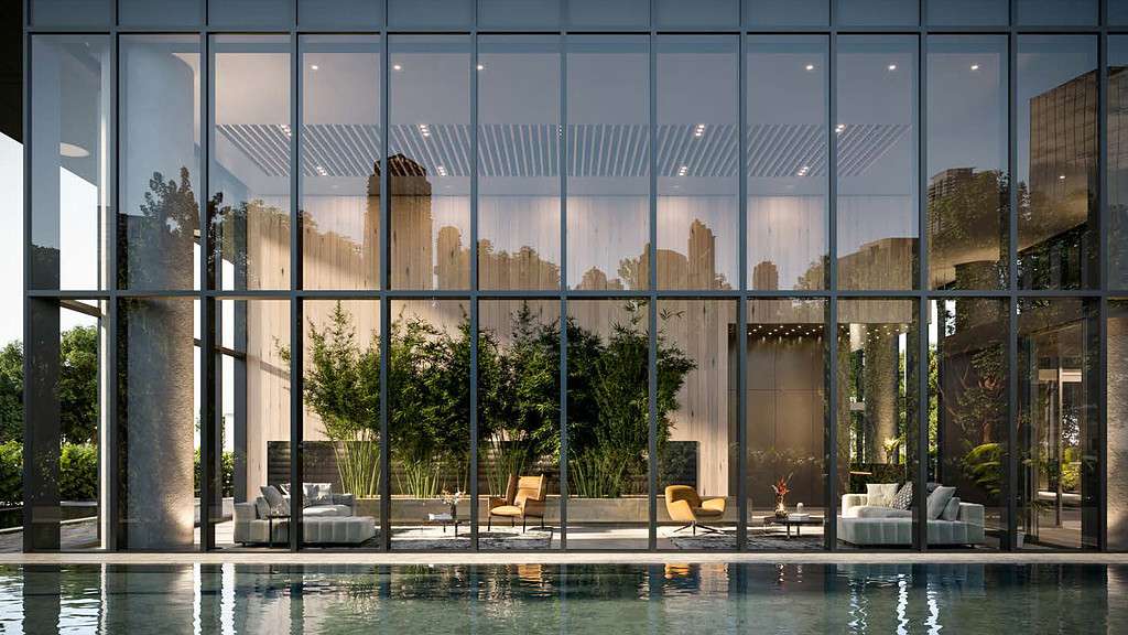 A large glass building with a pool.