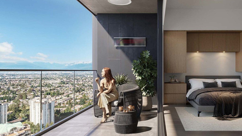 A person sitting on a chair in a room with a window and a view of a city.