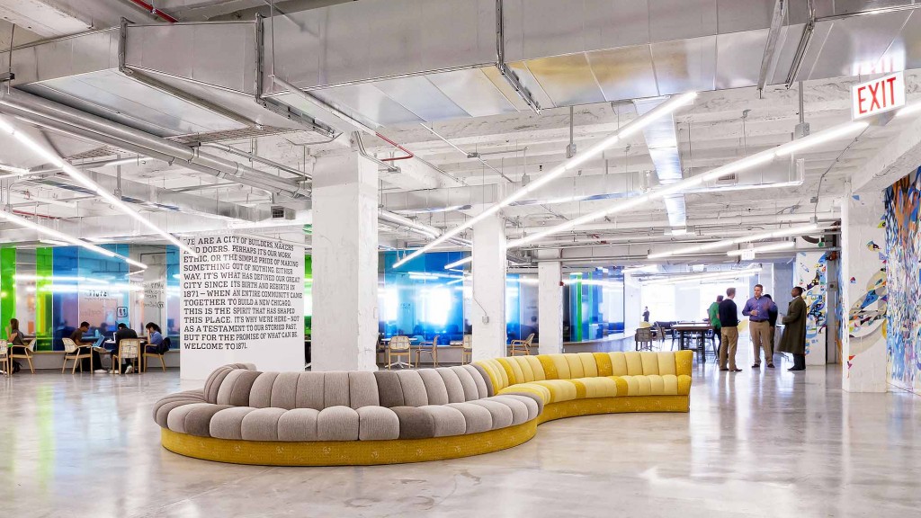 A large room with a large white and yellow couches.