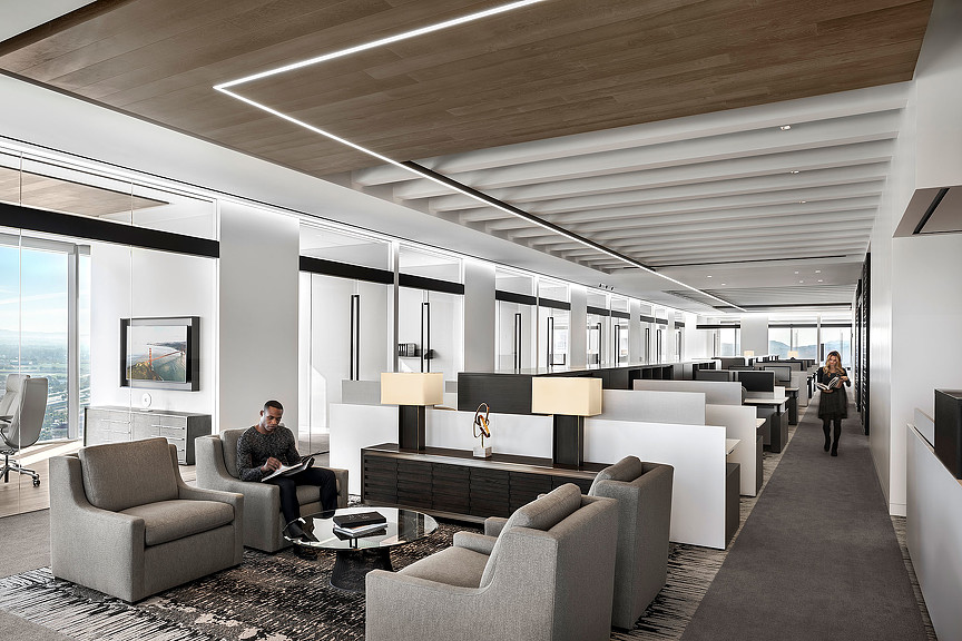 A person sitting in a chair in a living room.