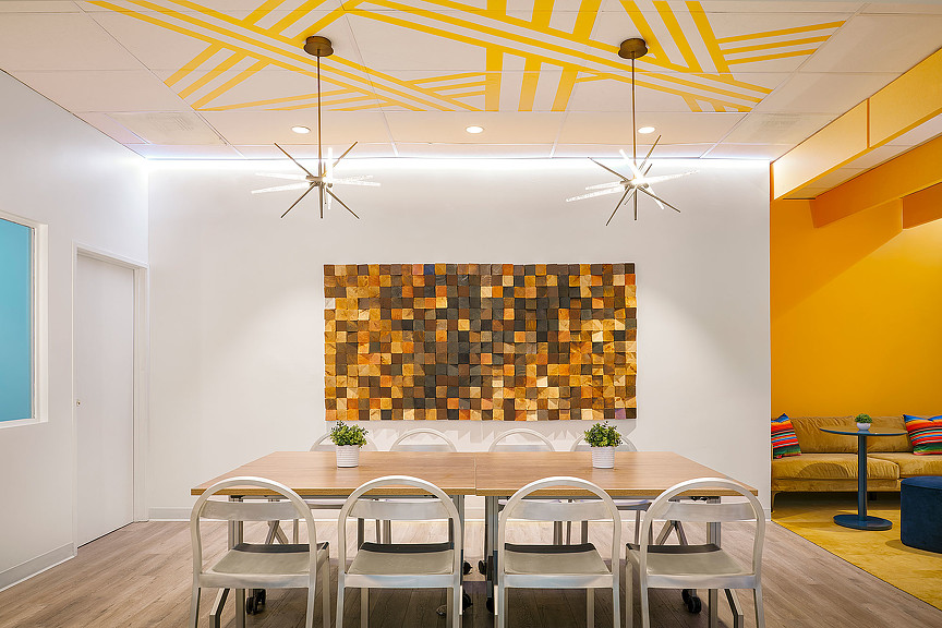 A dining room with a table and chairs.