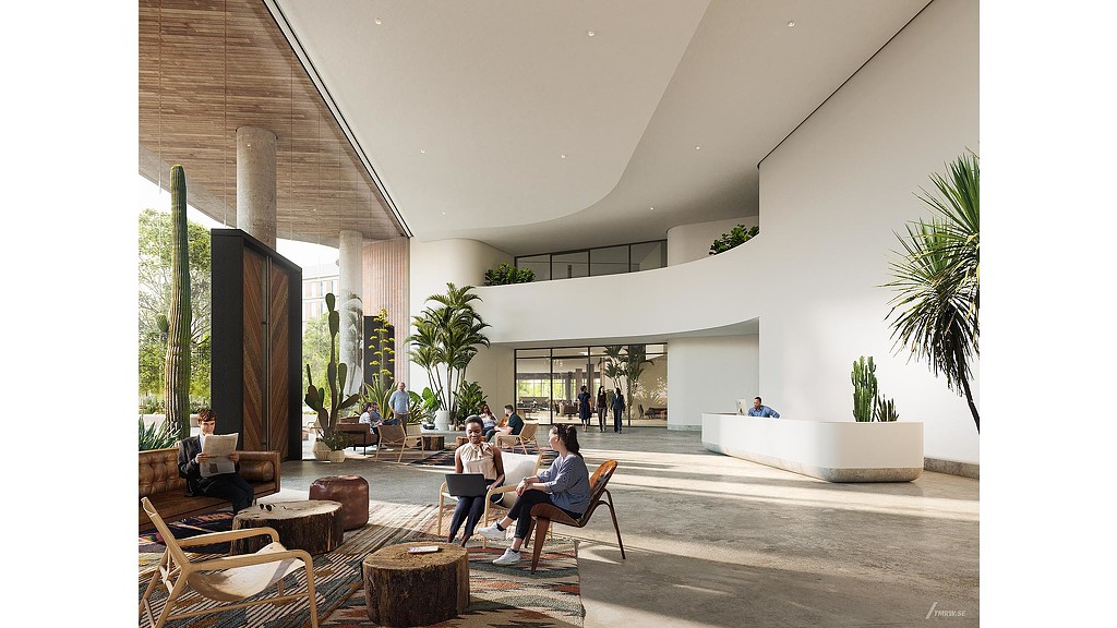 A group of people sitting in a room with a large white building.