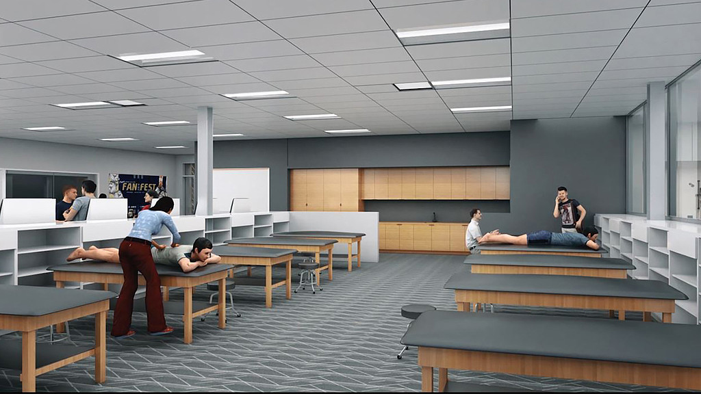 People sitting on benches in a room.