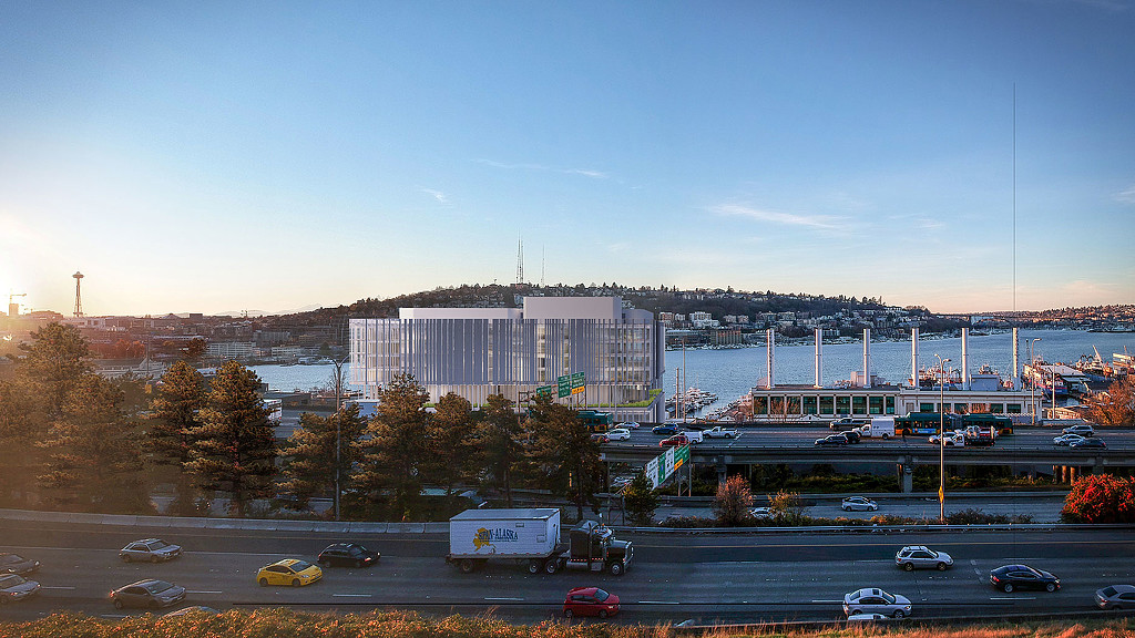 A large building with a body of water in the background.