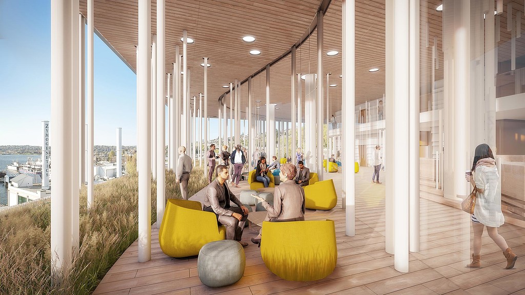 A group of people sitting on yellow and green lounge chairs.