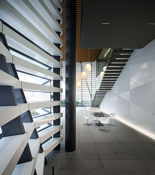 A room with a staircase and tables.