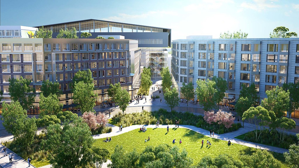 A group of people playing in a courtyard in front of a building.