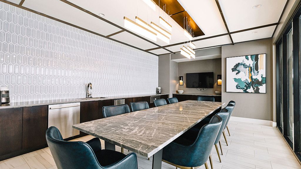 A room with a table and chairs.