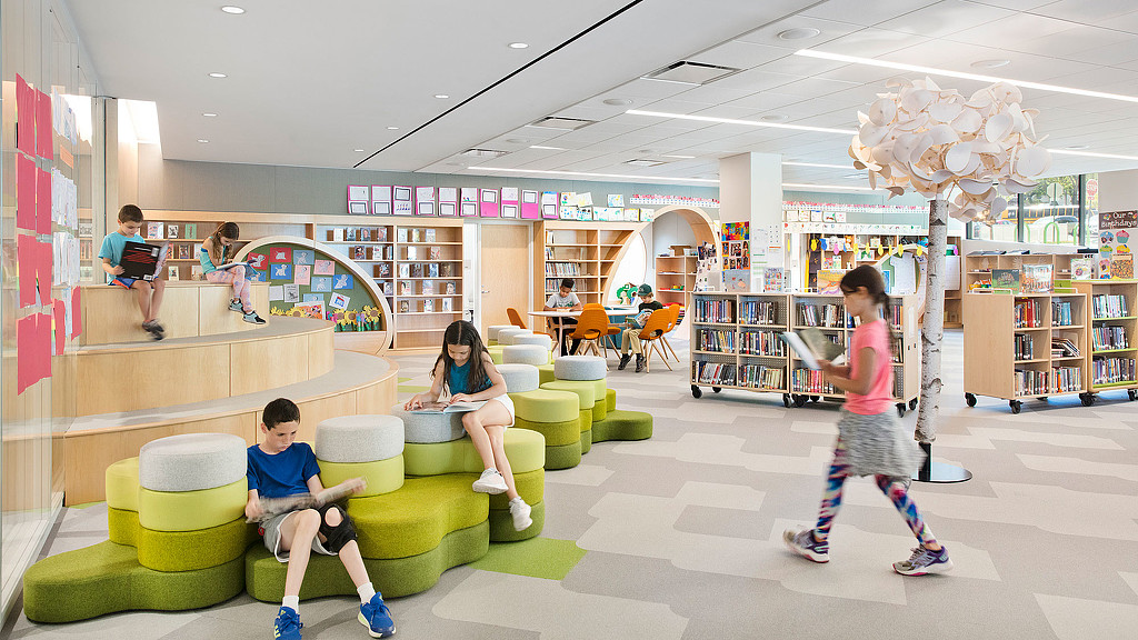 A group of people in a library.