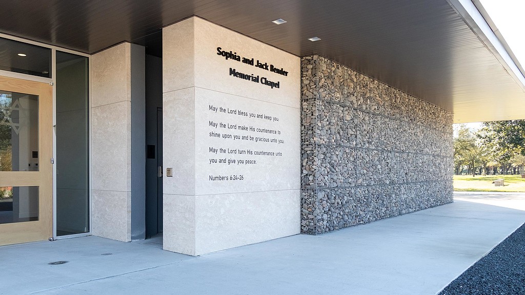 A stone wall with a sign on it.