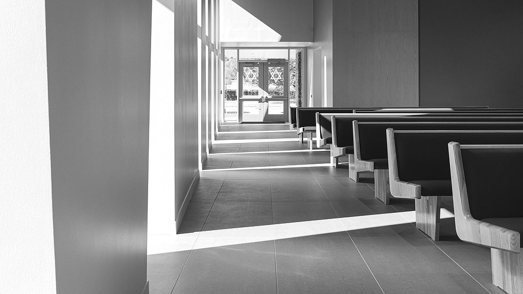A room with benches and a table.