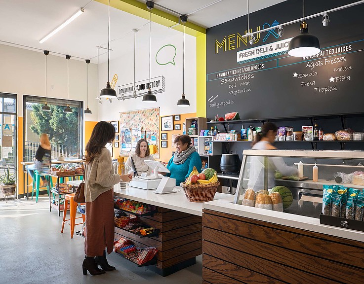 A person standing in front of a counter with food on it.