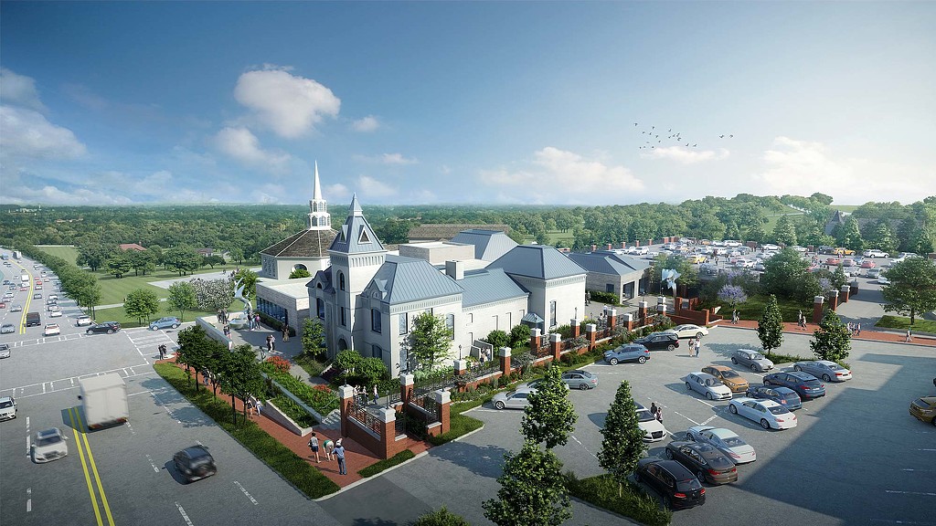 A large white building with a parking lot in front of it.