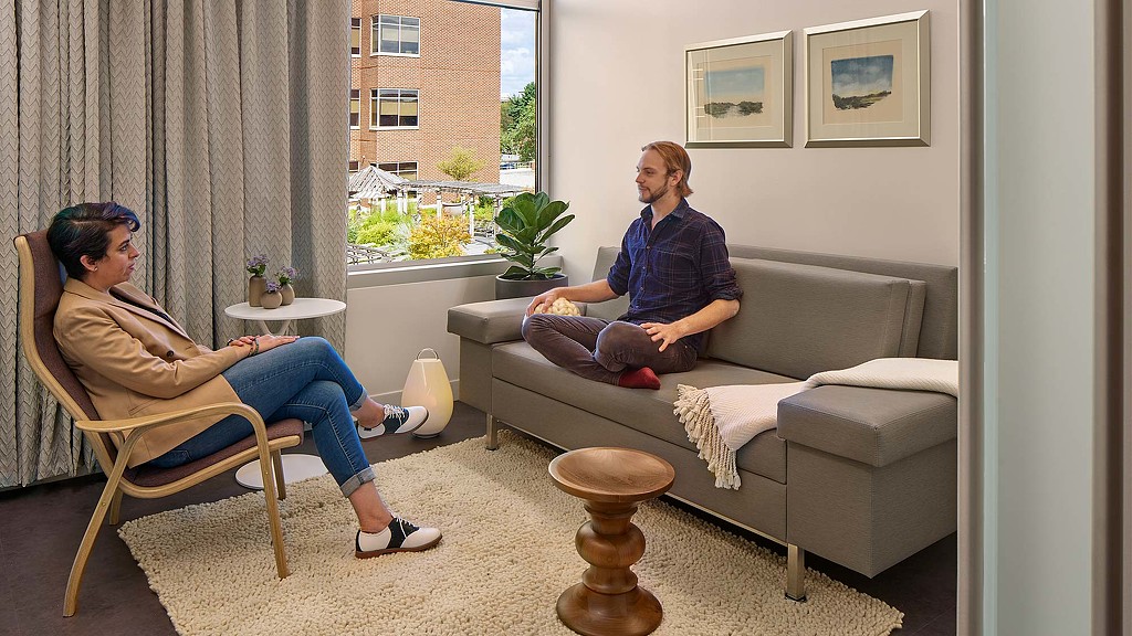 A man and a woman sitting on a couch.