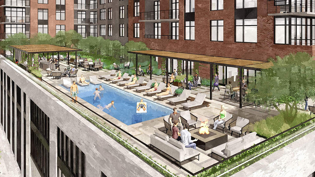 A pool with people sitting around it.