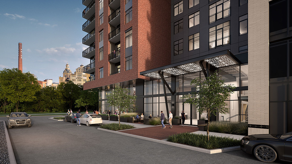 A street with cars and people on it next to a building.