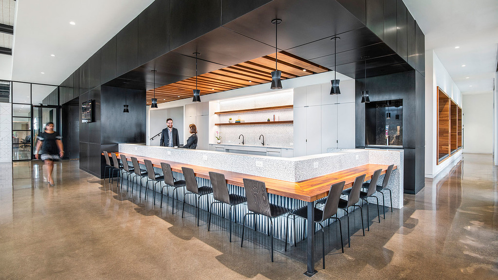 A large room with a table and chairs.